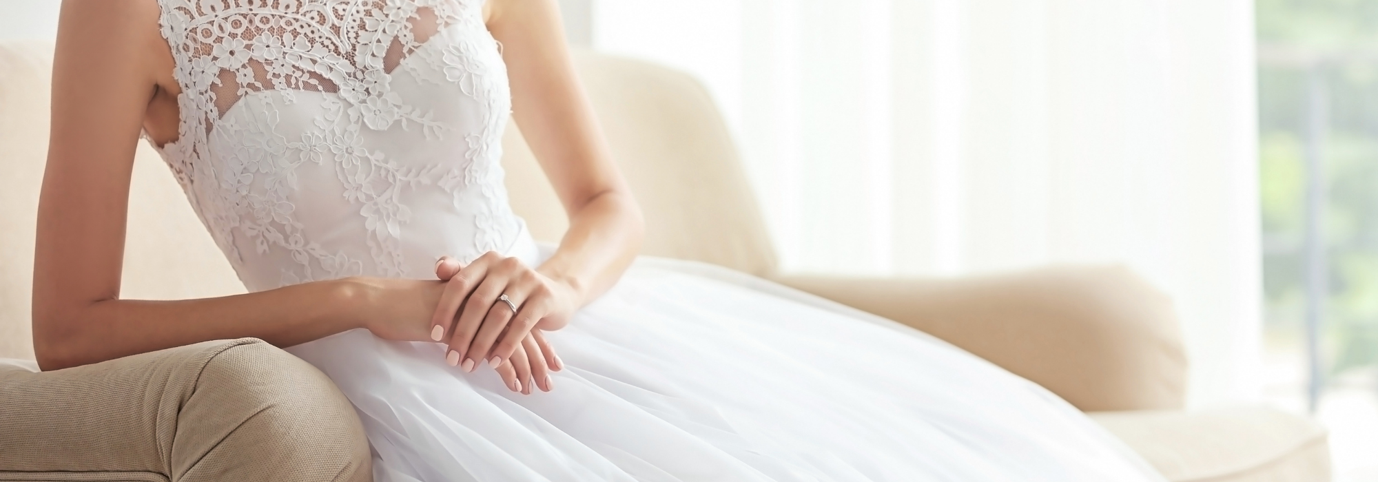 bride in an elegant off-white wedding dress sitting 
