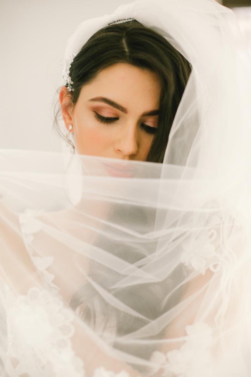 bride with flowing veil covering her face