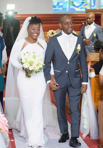 couple walking down aisle during church wedding ceremony